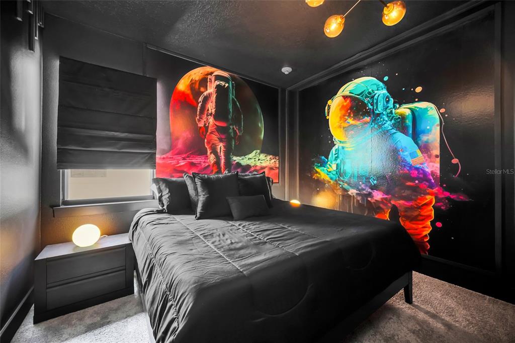 1213 Radiant Street Reunion, FL 34747 - Photo 20 of 84 a bedroom with a bed and a painting on the wall