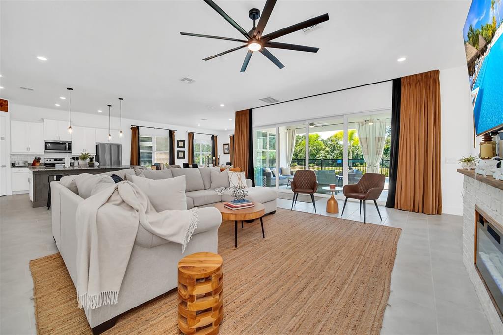 1213 Radiant Street Reunion, FL 34747 - Photo 32 of 84 a living room with furniture wooden floor and a large window