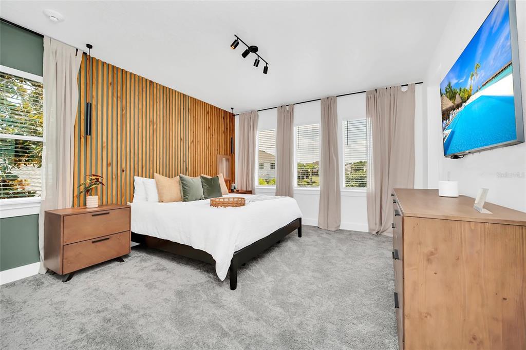 1213 Radiant Street Reunion, FL 34747 - Photo 45 of 84 a spacious bedroom with a bed and a window