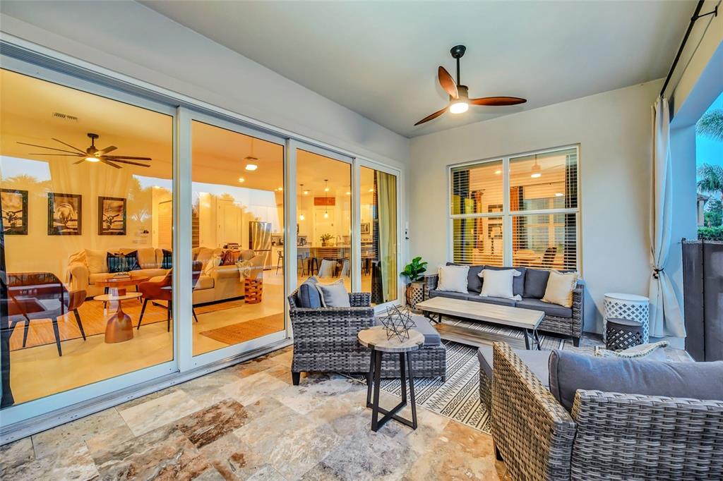 1213 Radiant Street Reunion, FL 34747 - Photo 73 of 84 a living room with furniture and a floor to ceiling window