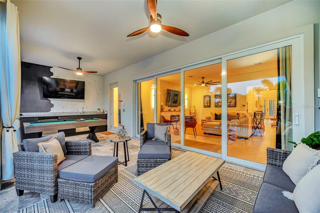 1213 Radiant Street Reunion, FL 34747 - Photo 75 of 84 a living room with furniture and a flat screen tv