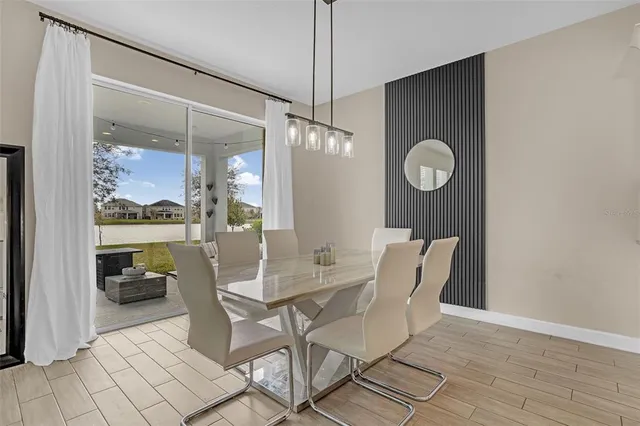 a dining room with furniture and window