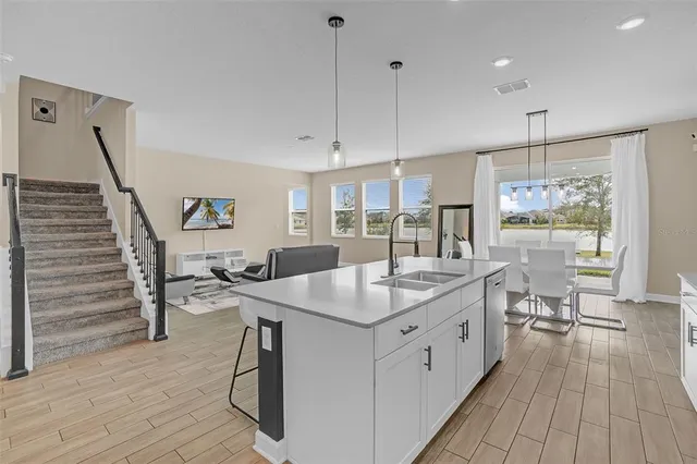 a kitchen with sink cabinets and wooden floor