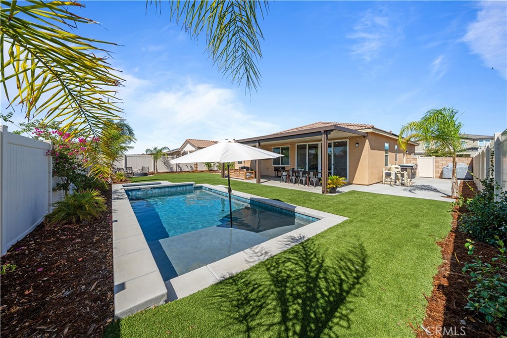 a view of a house with swimming pool and porch