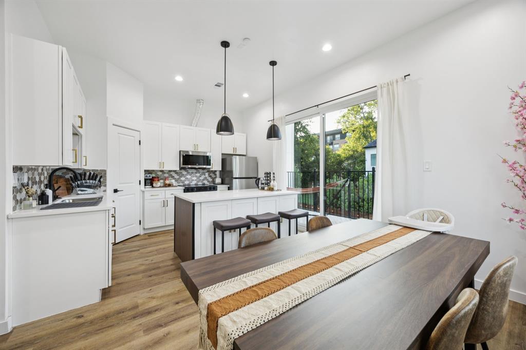 907 Bayonne Street Dallas, TX 75212 - Photo 11 of 38 a large kitchen with kitchen island a large counter top space a sink stainless steel appliances and cabinets