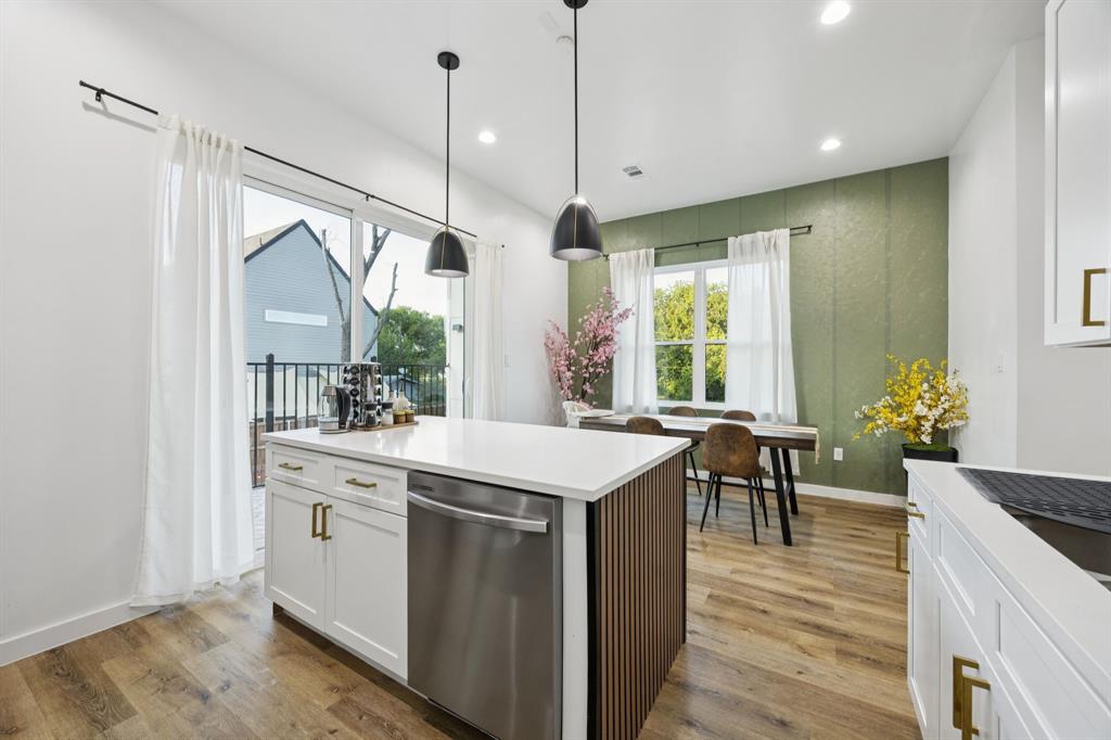 907 Bayonne Street Dallas, TX 75212 - Photo 14 of 38 a kitchen that has a lot of white cabinets and wooden floor