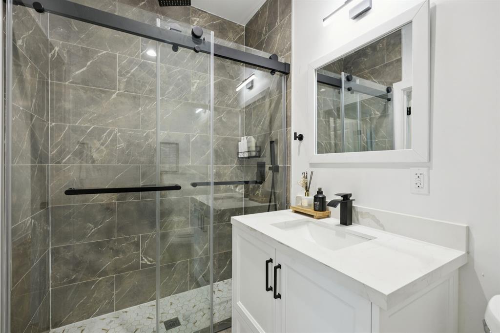 907 Bayonne Street Dallas, TX 75212 - Photo 19 of 38 a bathroom with a sink shower and a mirror