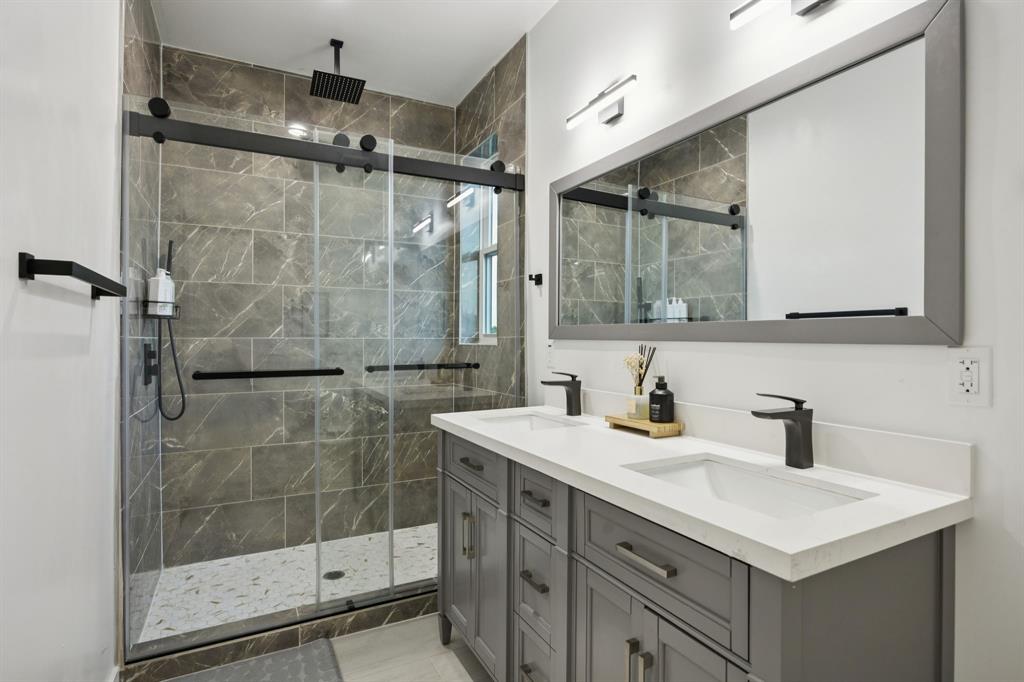 907 Bayonne Street Dallas, TX 75212 - Photo 22 of 38 a bathroom with a sink mirror and a shower