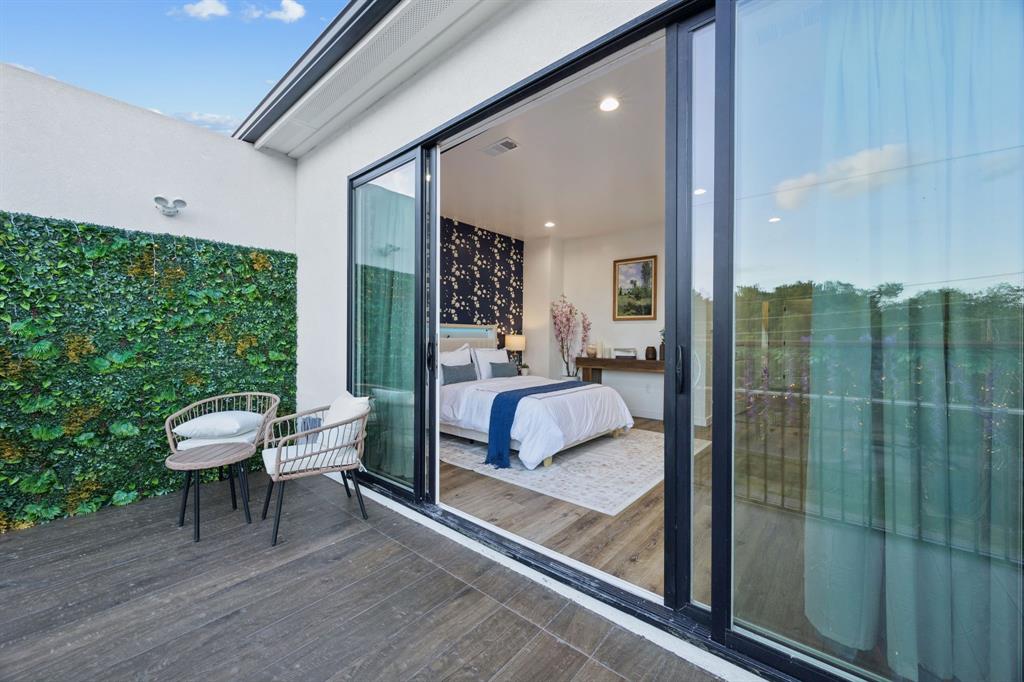 907 Bayonne Street Dallas, TX 75212 - Photo 37 of 38 a view of a bedroom with a bed and glass door