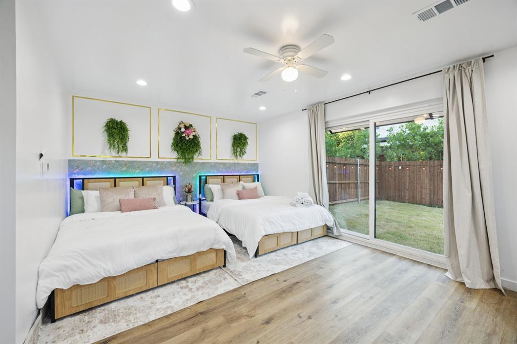 907 Bayonne Street Dallas, TX 75212 - Photo 5 of 38 a bedroom with a bed a window and a chandelier