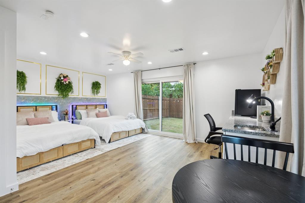 907 Bayonne Street Dallas, TX 75212 - Photo 6 of 38 a bedroom with furniture and a wooden floor