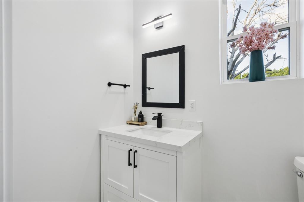 907 Bayonne Street Dallas, TX 75212 - Photo 9 of 38 a bathroom with a sink and a mirror