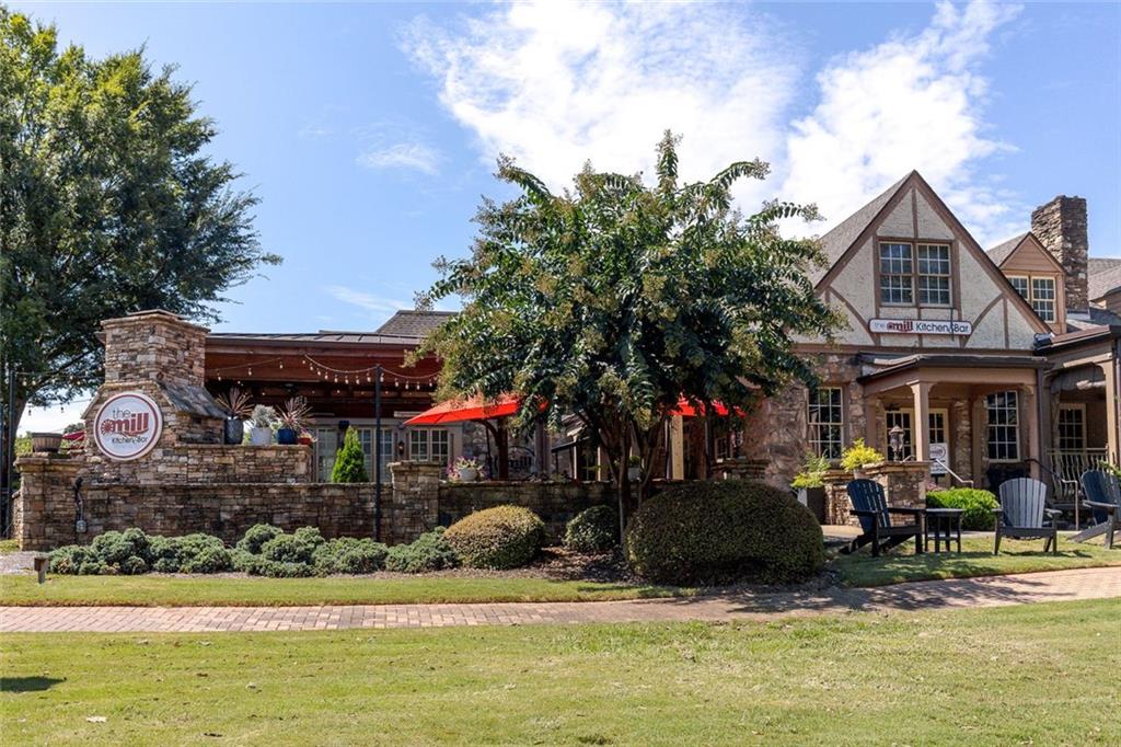 657 Willeo Road Roswell, GA 30075 - Photo 17 of 18 a front view of a house with a garden and swimming pool