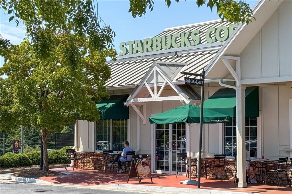 657 Willeo Road Roswell, GA 30075 - Photo 18 of 18 a view of a patio with table and chairs under an umbrella