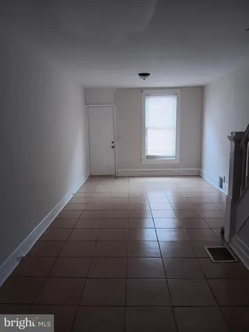 a view of a livingroom with an empty space and a window