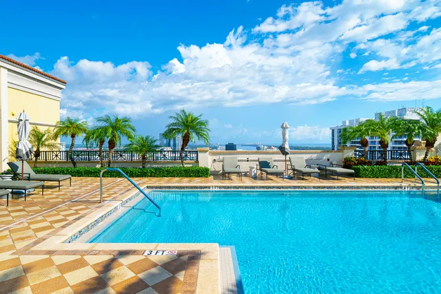 a view of a swimming pool with an outdoor seating