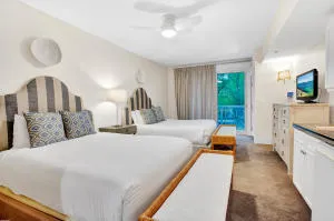 a spacious bedroom with a bed and a flat tv screen