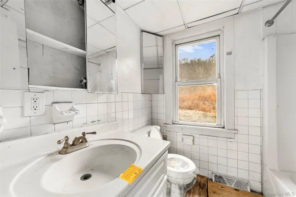 a large white kitchen with a wooden floor