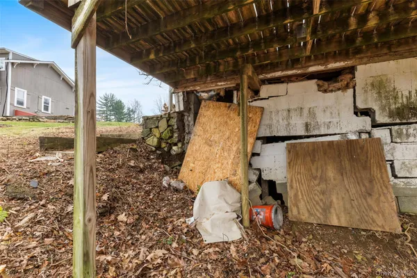 a view of a wooden house with a small yard