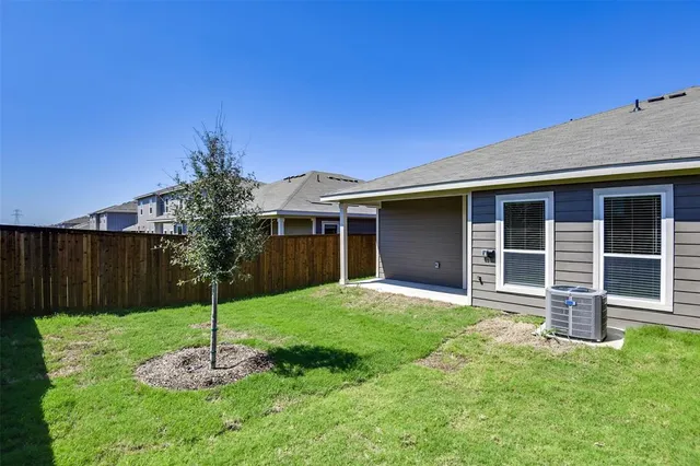 a backyard of a house with potted plants