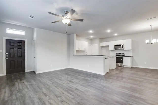 a view of kitchen with cabinets and wooden floor