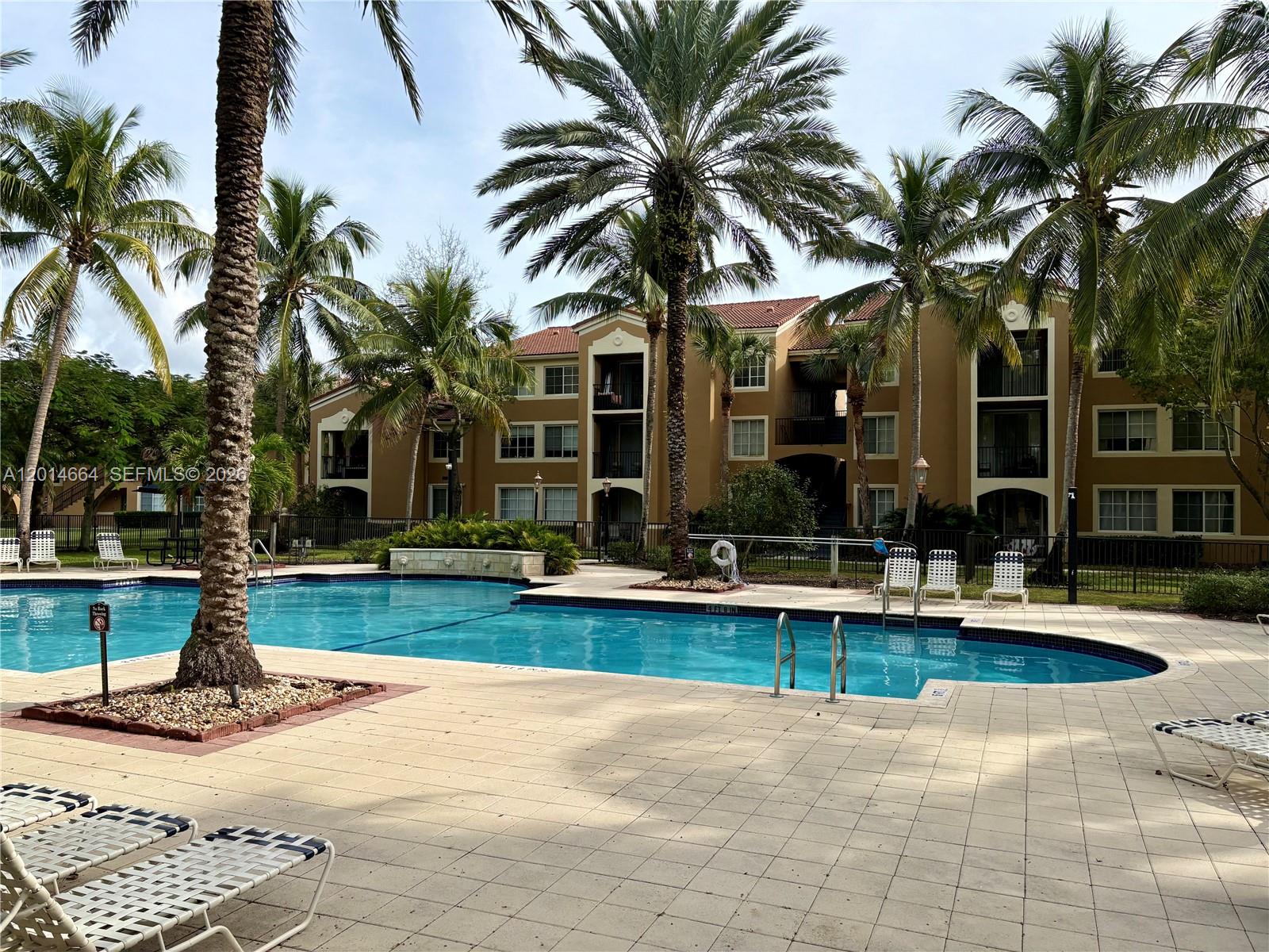8030 North Nob Hill Road, Unit 105 Tamarac, FL 33321 - Photo 17 of 22 a view of a house with swimming pool and sitting area