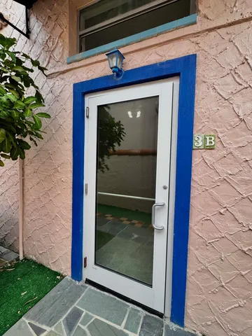 an empty room with a ceiling fan and entryway