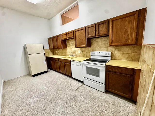 a kitchen with stainless steel appliances a refrigerator and a stove