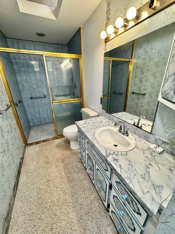 a bathroom with a tub shower and sink