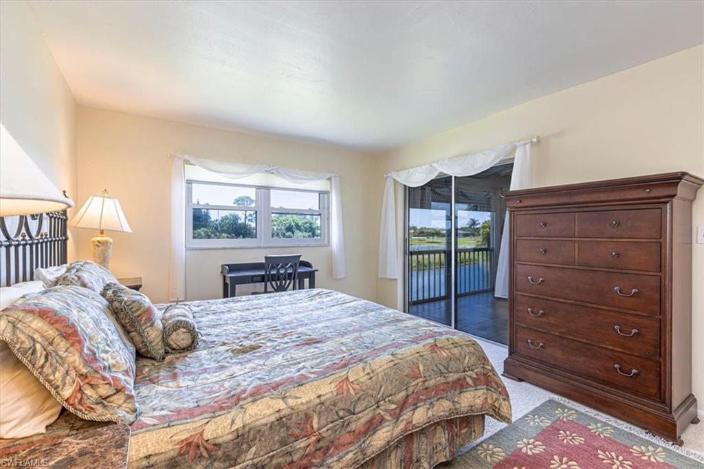 5483 Rattlesnake Hammock Road, Unit B201 Naples, FL 34113 - Photo 15 of 22 a bedroom with a large bed and a window