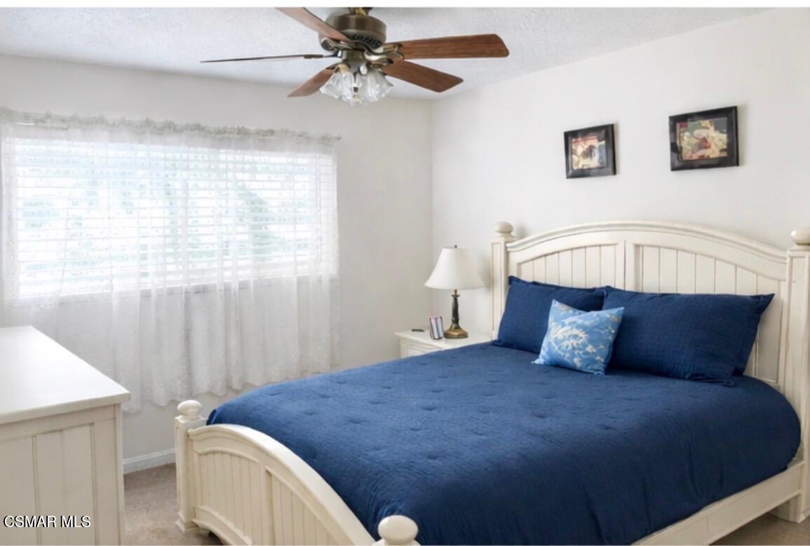 2124 Cutler Street Simi Valley, CA 93065 - Photo 3 of 5 a bedroom with a bed and a chandelier