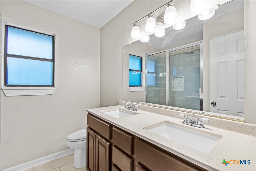 180 County Road 4933 Kempner, TX 76539 - Photo 12 of 24 a bathroom with a sink a toilet and a mirror