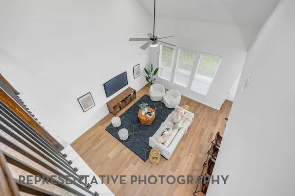 a living room with furniture and floor to ceiling window