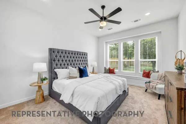 a bedroom with a large bed and a window