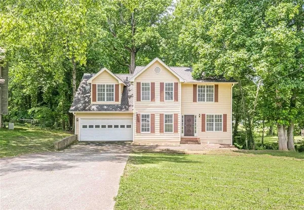 a front view of a house with a yard
