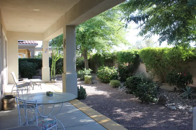 a living room with patio furniture and a potted plants