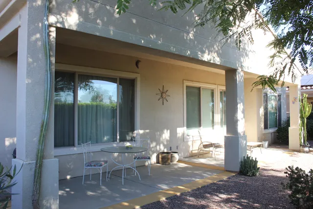 a front view of a house with outdoor seating