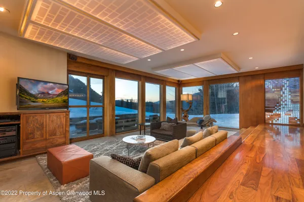 a living room with furniture and a floor to ceiling window