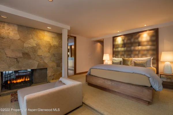 a bedroom with furniture and a large window