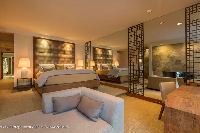 a bedroom with a bed and lamp with window