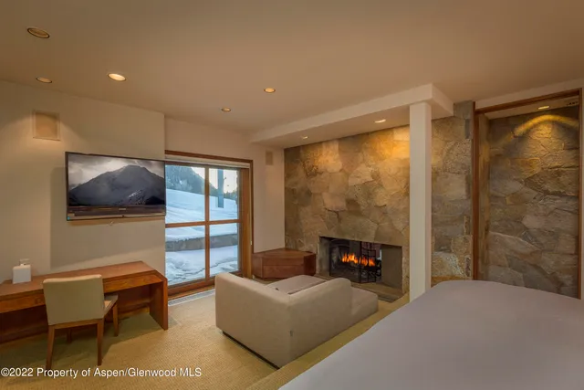 a large bedroom with bed and glass door