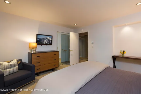 a large bedroom with a large bed and furniture