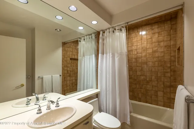 a bedroom with a bed and a large mirror