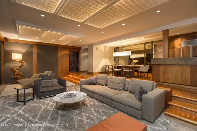 a living room with furniture and a chandelier