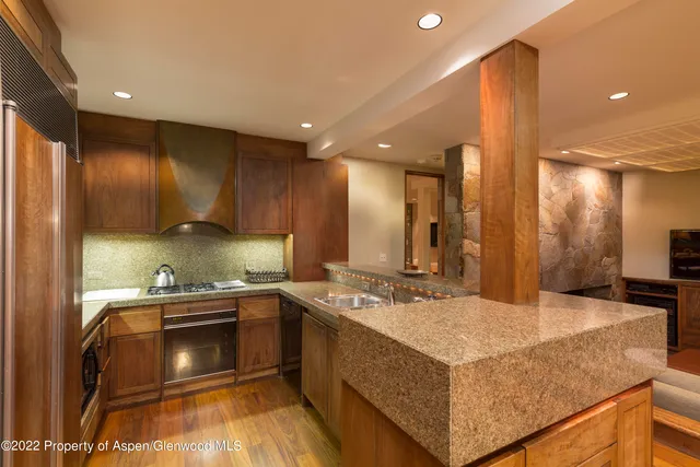 a spacious bedroom with a bed and a fireplace