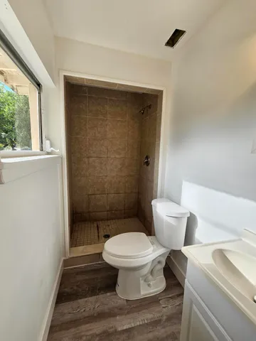 a bathroom with a toilet and a shower