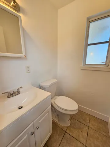 a bathroom with a sink a toilet and mirror