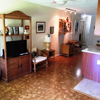 a living room with furniture a flat screen tv and a table