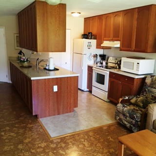 1032 South Kihei Road, Unit A203 Kihei, HI 96753 - Photo 2 of 13 a kitchen with stainless steel appliances a stove a sink a refrigerator and cabinets
