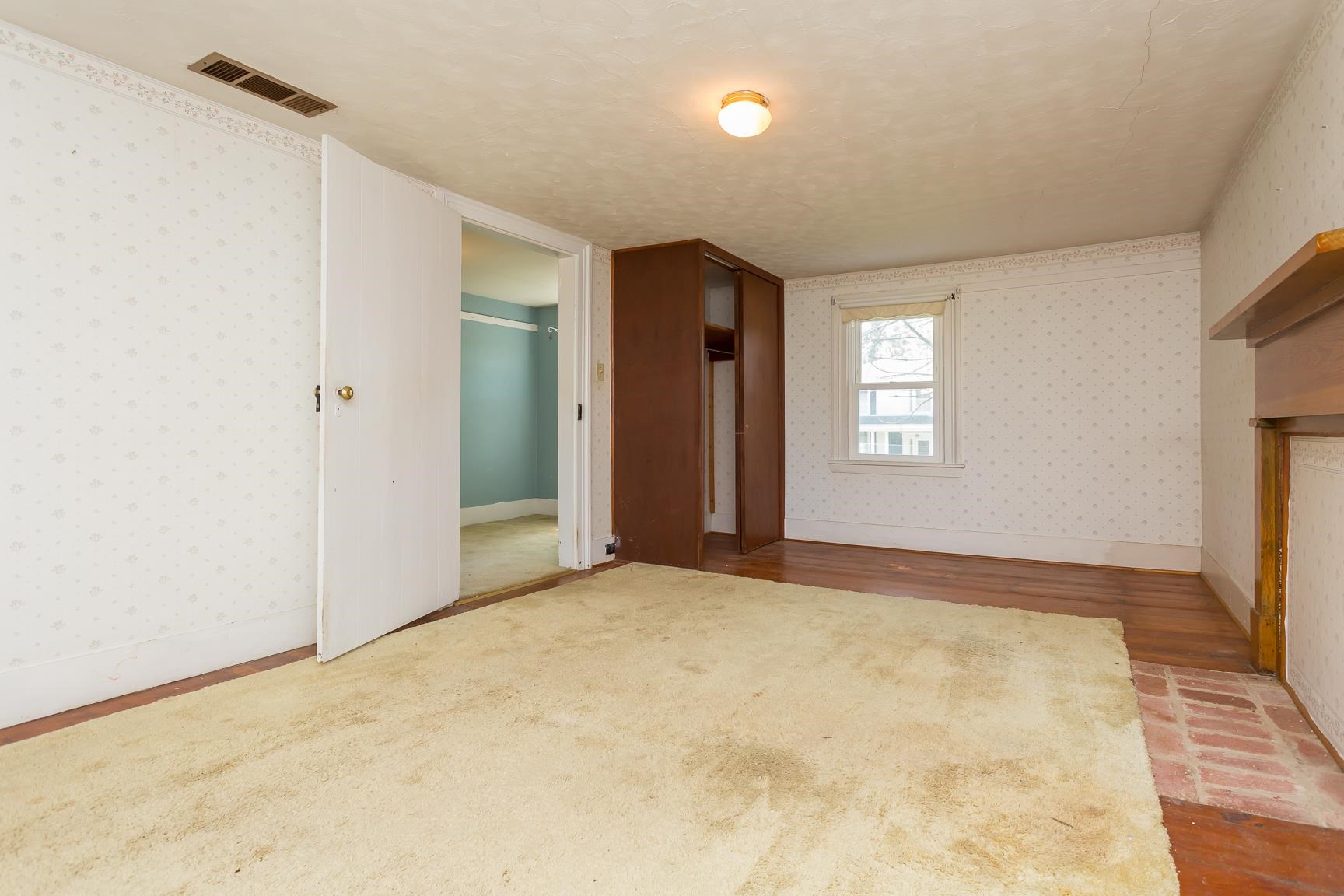 572 Battlefield Road New Hope, VA 24437 - Photo 24 of 39 a view of an empty room with window and wooden floor